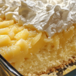 Juicy Pineapple Heaven Cake topped with whipped cream and crushed pineapple, served on a dessert plate.