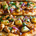 Hawaiian BBQ Chicken Flatbread topped with grilled chicken, pineapple, red onion, melted cheese, and BBQ sauce.