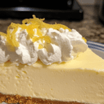 Chilled no-bake lemonade pie with cream cheese and a zesty lemon flavor, garnished with lemon slices.