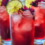 Long Beach Iced Tea with a hibiscus twist, served in a tall glass with a floral pink hue and citrus garnish.